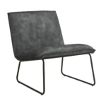 De Fauteuil James - Velvet Antraciet is een moderne armloze loungestoel met een zwart metalen frame en donkergrijze fluwelen beklede zitting en rugleuning, met een minimalistisch, eigentijds ontwerp.