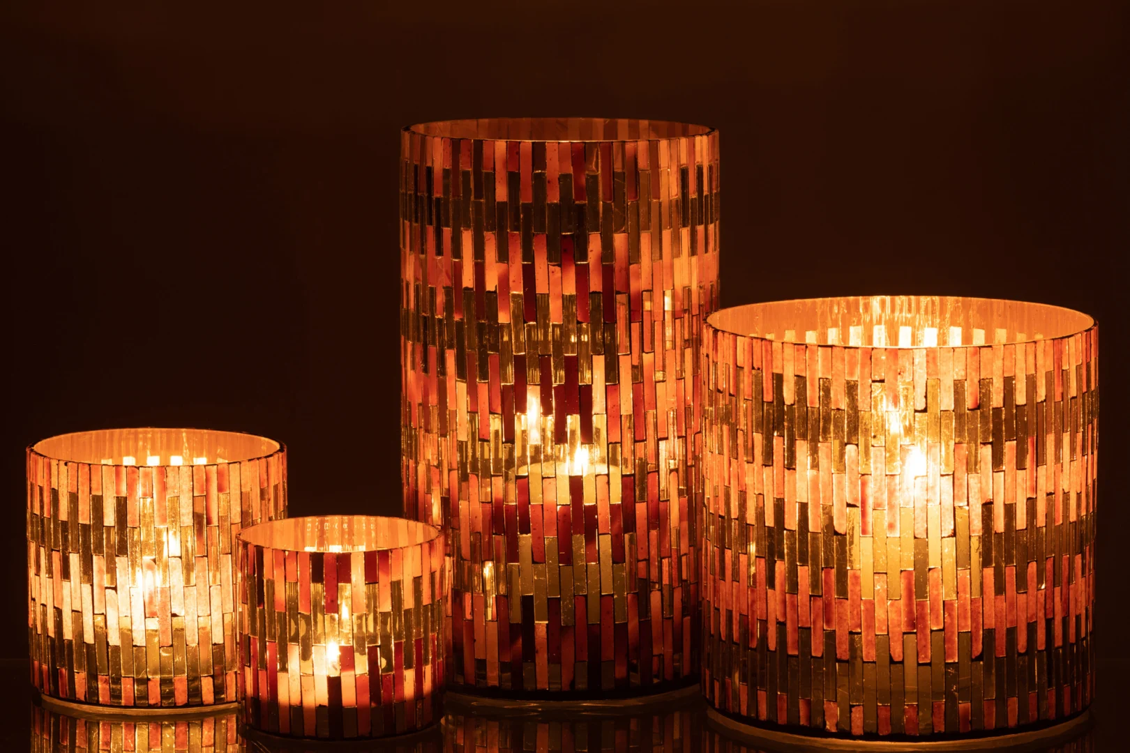 De Kaarsenhouder Orkaan Chic Glas Bruin Goud Groot heeft een warm, gloeiend patroon van verticale gouden en koperen strips, die een gezellig sfeerlicht verspreiden wanneer er een kaars wordt aangestoken, perfect voor een elegante inrichting.