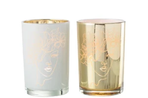 Set van twee Kaarsenhouder Orkaan Dame Bloemen glazen kandelaars, een witte en een gouden, elk met een minimalistische gouden lijntekening van een vrouwengezicht met bloemen in het haar.