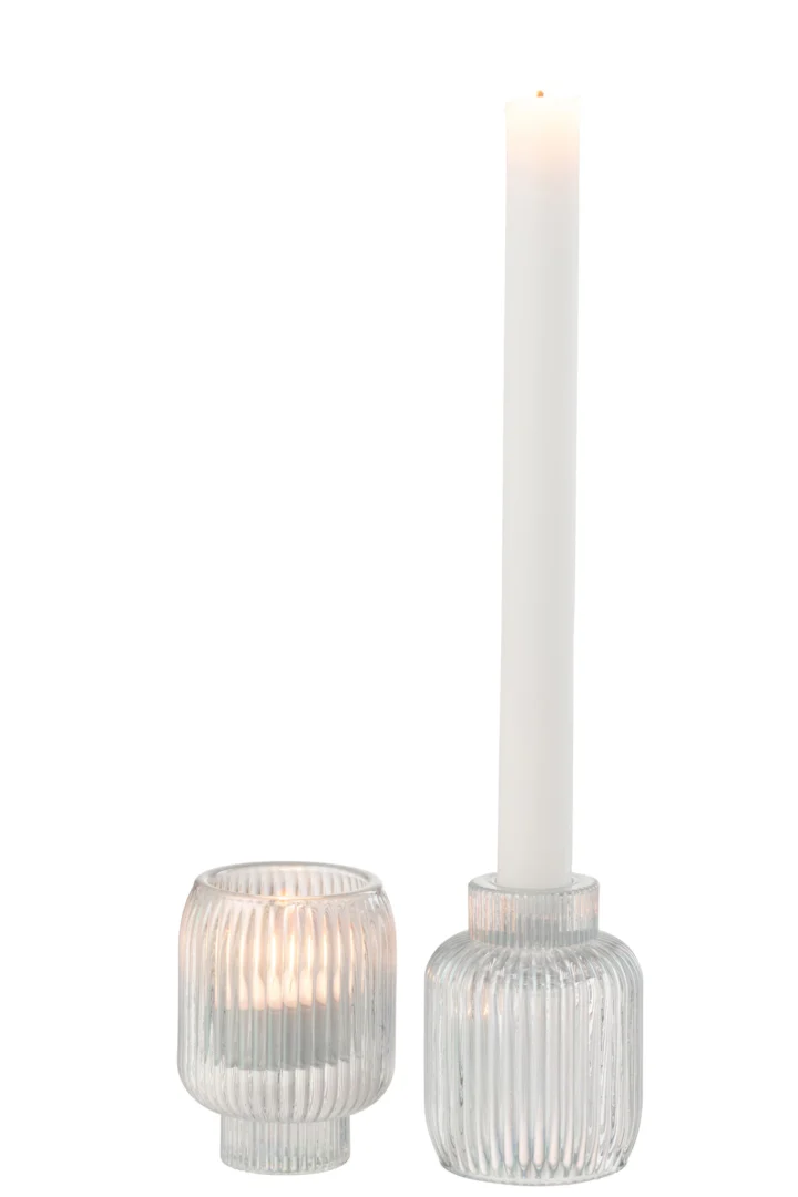 Twee Kaarsenhouder Rib Glas Parel Transparant worden getoond: één met een klein waxinelichtje en één met een hoge witte dinerkaars. Beide kaarsen branden en verspreiden een zachte gloed.