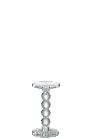 De Kaarsenhouder Druppels Glas Transparant Medium is een kaarsenhouder van helder glas met een ronde basis, een ronde bovenkant en een steel gevormd door vier gestapelde glazen bollen voor een eenvoudige, minimalistische look.