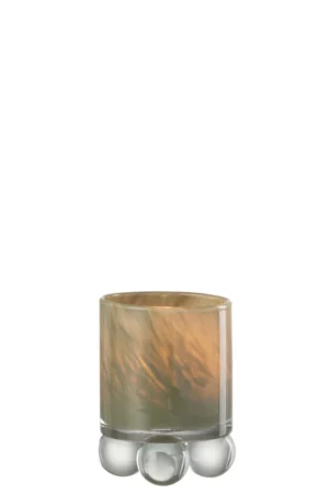 Theelichthouder Ballen Glas Groen is een doorschijnende, cilindervormige houder met een gemarmerd beige en grijs patroon, geplaatst op drie heldere glazen bollen tegen een witte achtergrond.