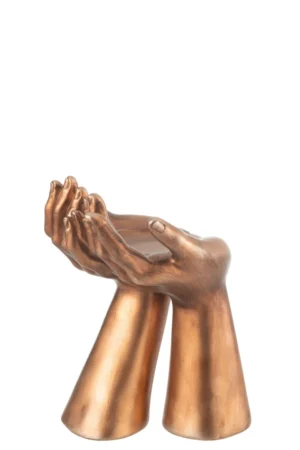 De Kaarsenhouder Palmen Hars Koper is een bronskleurige kandelaar met twee gladde, minimalistische handen met omgekeerde handpalmen en verbonden polsen die samen een stevige basis vormen.