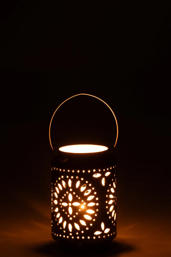 De Kaarsenhouder Orkaan Nag IJzer Blauw Wit Klein is een decoratieve lantaarn met bloemvormige uitsparingen die een warme, zachte gloed en gedessineerde schaduwen werpt als hij brandt. De lantaarn heeft een afgerond handvat zodat je hem gemakkelijk kunt dragen.