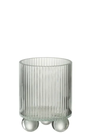 De Kaarsenhouder Orkaan Clara Glas Klein is een heldere, geribbelde glazen kandelaar met een cilindrische vorm, ondersteund door drie ronde glazen bolpootjes, afgebeeld tegen een witte achtergrond.