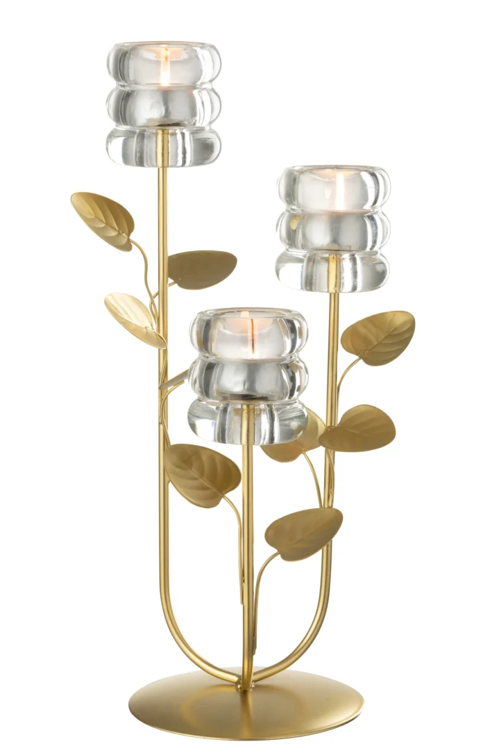 De Kaarsenhouder Tak Blad 3 Delen IJzer Goud Transparant is een goudmetalen kaarsenhouder met drie takken, elk met een bloemvormig helder glazen kopje en bladgoudversieringen. In de glazen houders branden drie waxinelichtjes.