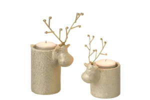 De Theelichthouder Rendier Porselein Wit Goud Set 2 bestaat uit twee kandelaars met goudstructuur, elk met een rendierkop en metalen gewei, verschillende hoogtes, witte waxinelichtjes erin en een feestelijke uitstraling.