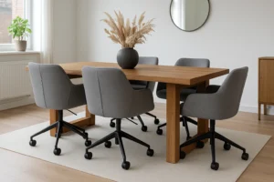 Een moderne eethoek met een houten tafel, zes grijze draaistoelen op wieltjes - wil je weten waarom zijn grijze eetkamerstoelen zo populair? Een vaas met gedroogd gras, een ronde wandspiegel en natuurlijk licht van grote ramen maken de look compleet.