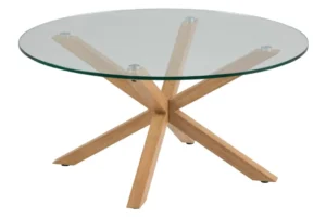 De Salontafel 82 CM Rond Kunststof is een ronde salontafel met een helder glazen blad en een modern houten onderstel met vier schuine poten die elkaar in het midden kruisen.