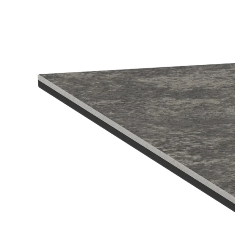 Een close-up van de hoek van de Salontafel Zwart 130 x 70 CM Rechthoek, met een dun, donker keramisch blad met een gestructureerd oppervlak en rechte, strakke randen.