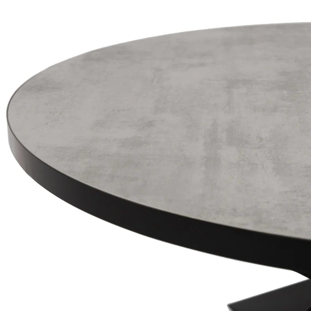 Een close-up van de Stalux Ronde eettafel 'Daan' 135cm in zwart/beton, met een glad, betonlook grijs oppervlak met een slanke zwarte rand, getoond tegen een witte achtergrond.