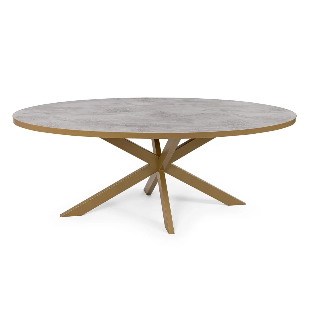 De Stalux Ovale eettafel 'Mees' (240 x 110cm) heeft een lichtgrijs, steenachtig blad en een modern goudkleurig metalen onderstel met vier schuine poten die elkaar in het midden kruisen.