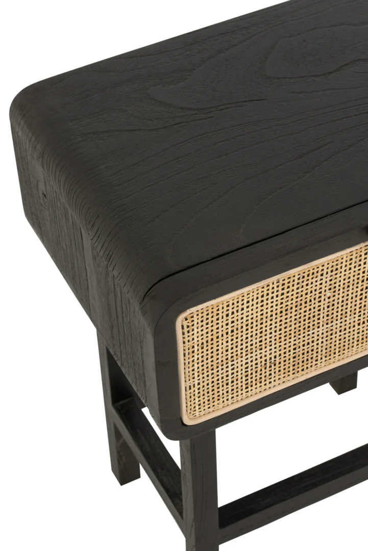 Een close-up van het Nachtkastje Zwart Industrieel (37 x 45 x 60 CM) toont de donkere houten afwerking, het stevige rechthoekige ontwerp en het geweven rotanpaneel aan de voorkant, dat de stijlvolle structuur benadrukt.