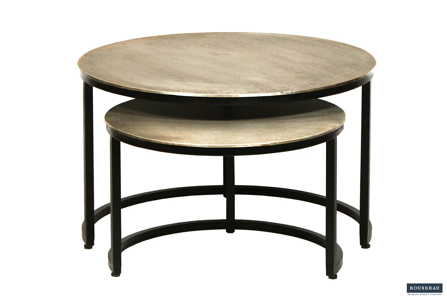 De Salontafel Zilver Compact bestaat uit twee ronde nesttafels met metalen frames en stenen bladen. De kleinere tafel schuift gedeeltelijk onder de grotere. Modern, minimalistisch ontwerp met een klein Rousseau-logo in de rechterbenedenhoek.