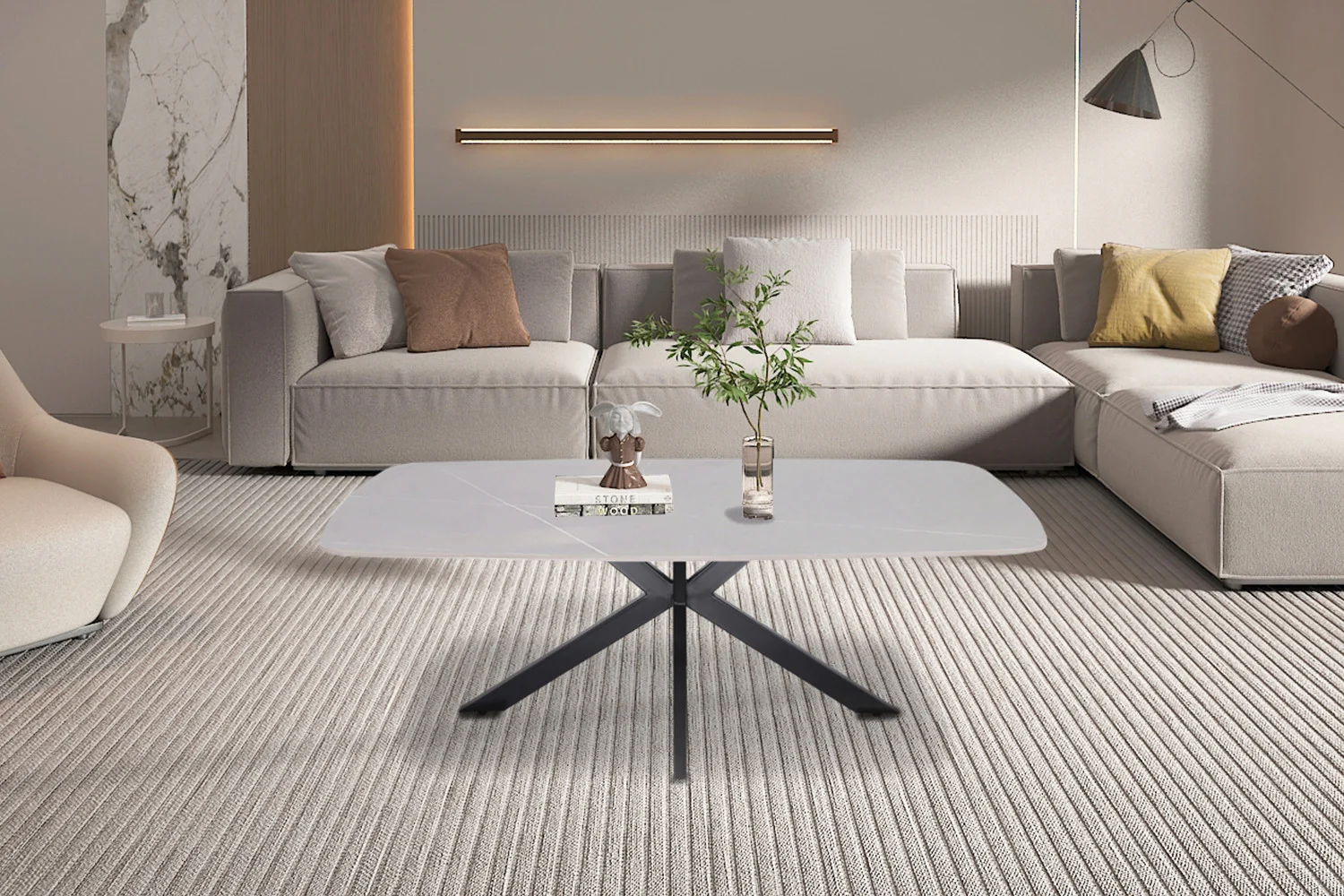Moderne woonkamer met lichte banken, een klassieke Salontafel Grijs 130 CM Ovaal Steen met een glazen vaas met groene takken en boeken, beige tapijt met textuur en zachte sfeerverlichting op een neutrale muur.
