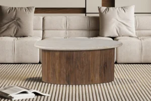 In een moderne woonkamer staat een lichtbruine bank met twee kussens, een Salontafel Beige 90 x 55 CM Travertin salontafel en een open boek op een gestreept beige vloerkleed.