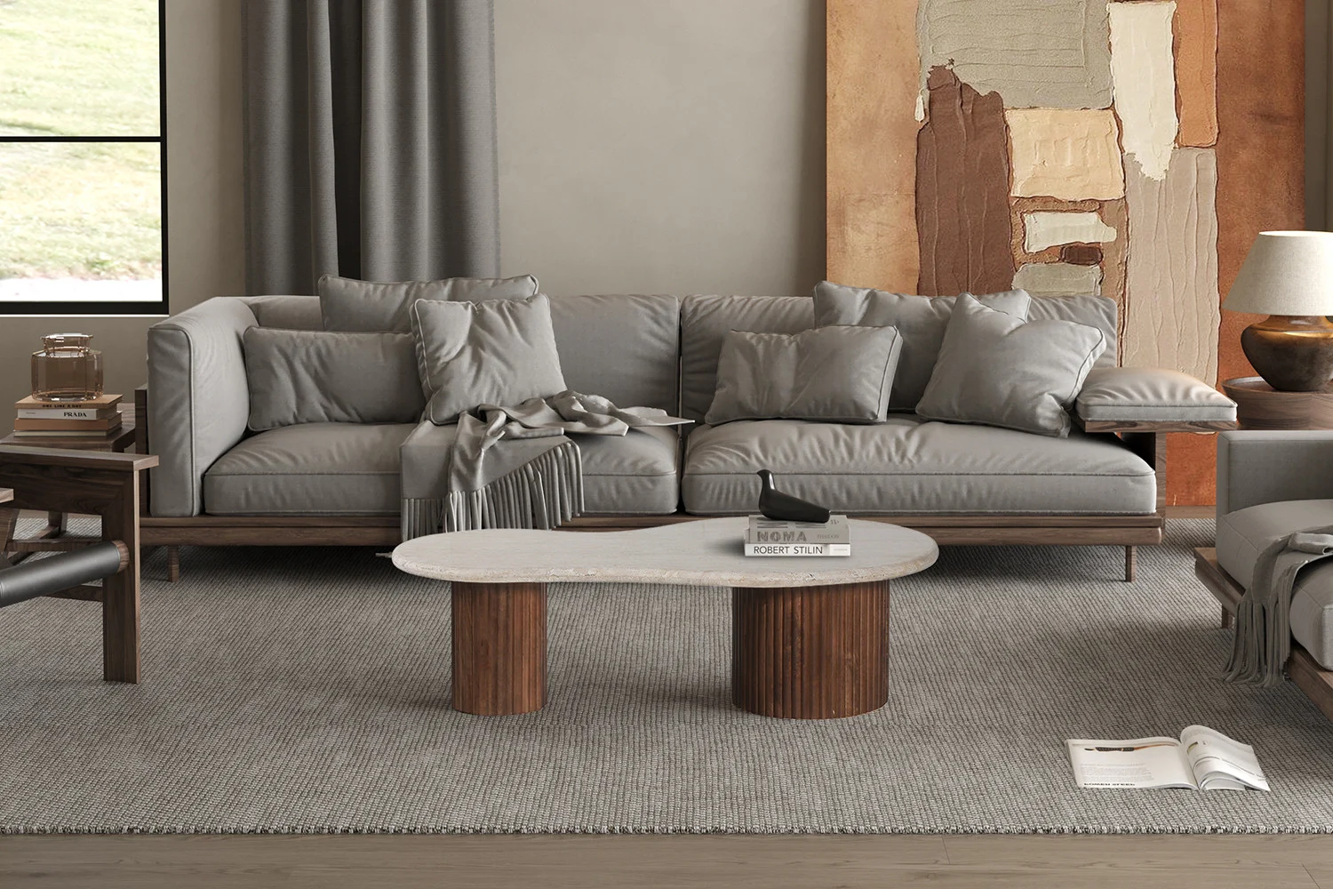 Een moderne woonkamer met een grijze sectionele bank, bijpassende kussens, een Salontafel Beige 120 CM Travertin salontafel, abstracte muurkunst, een lamp en een open tijdschrift op een grijs vloerkleed.