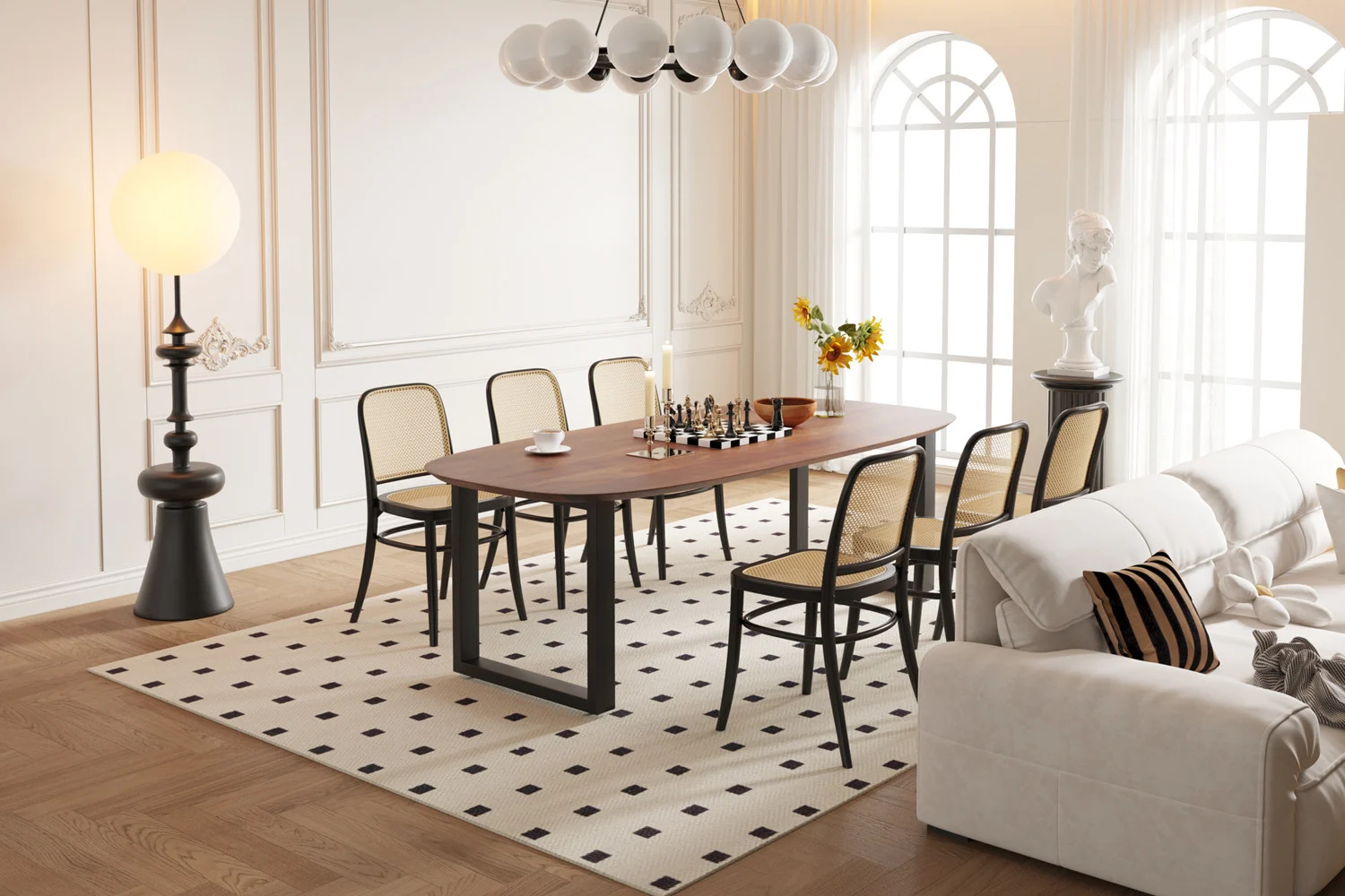 In een moderne eetkamer staat de UITVERKOOP - Tafel 'Tommy' 220x100 cm Deens Ovaal U-Poot in bruin mangohout, met een schaakset en omringd door zes stoelen op een vloerkleed met patroon, met grote ramen, een elegante inrichting en gezellige heldere verlichting.