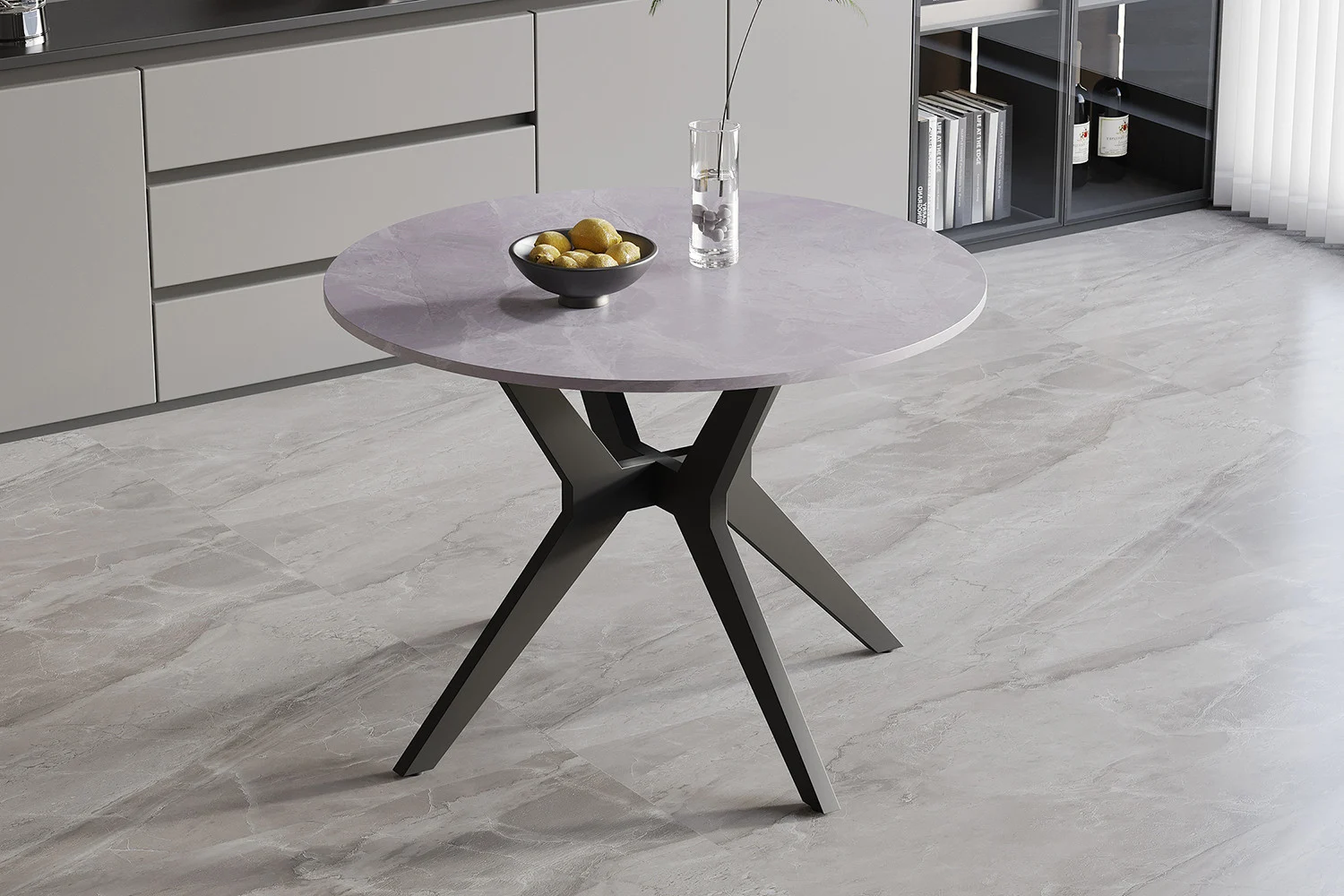 De Tafel 'Apollo' 110 cm Rond Glanzend Steen Italiaans Grijs staat op een grijs marmeren vloer, met een fruitschaal in het midden in een lichte, minimalistische keuken, met een moderne, hoekige zwarte basis en een licht, glanzend oppervlak.
