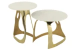 Twee Bijzettafels Goud, Wit 51 x 38 CM hebben ronde witte bladen en sculpturale gouden aluminium onderstellen, dicht bij elkaar geplaatst op verschillende hoogtes voor een moderne look.