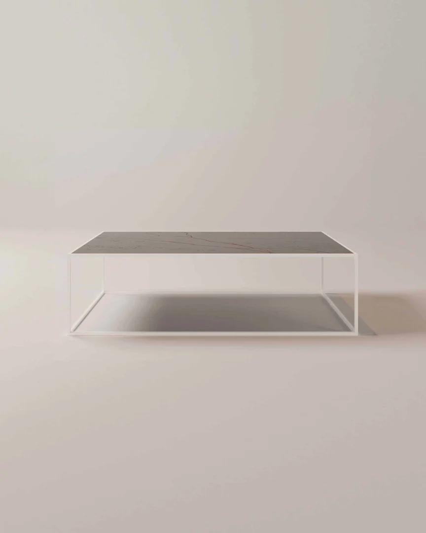 De Salontafel Wit 144 x 40 CM Rond is een minimalistische ronde salontafel met een slank, donker tafelblad en een open wit metalen frame, afgebeeld tegen een lichte achtergrond.