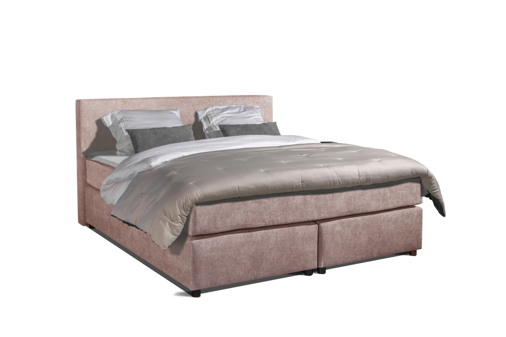 Roze boxspring stof met hoofdbord, dekbed en kussens op een witte achtergrond. De boxspring heeft een pocketvering en 7 zones.