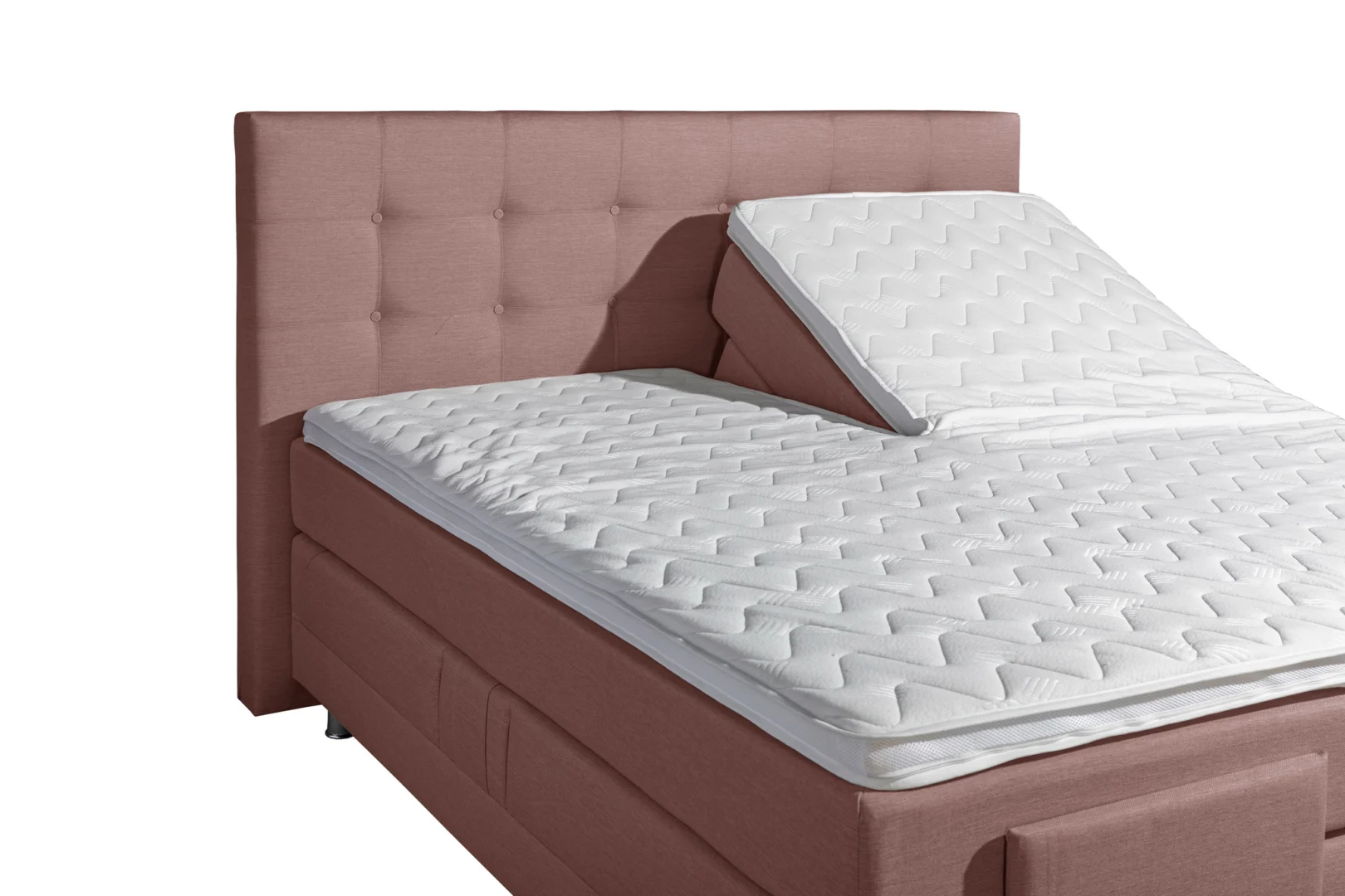 Roze boxspring met wit matras en hoofdbord. De boxspring is elektrisch verstelbaar en heeft 7 zones. Zijaanzicht bij helder licht.