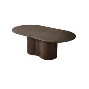 De TAURUS CT BRUIN FINEER PLAIN 130X70X45 is een donkerbruine ovale houten tafel met een dik, uniek gebogen, verticaal gegroefd voetstuk, tegen een effen witte achtergrond.
