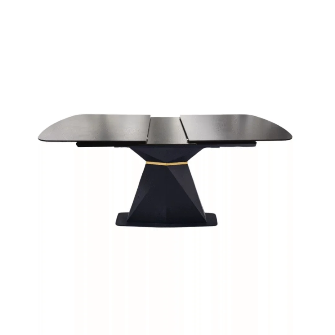 De JUMP DT ZWART 160/200x90 DONKERGRIJS 2326 SINTER STEEN is een rechthoekige donkergrijze eettafel met een voetstuk, gouden accent, licht afgeronde hoeken en een centraal verlengstuk.