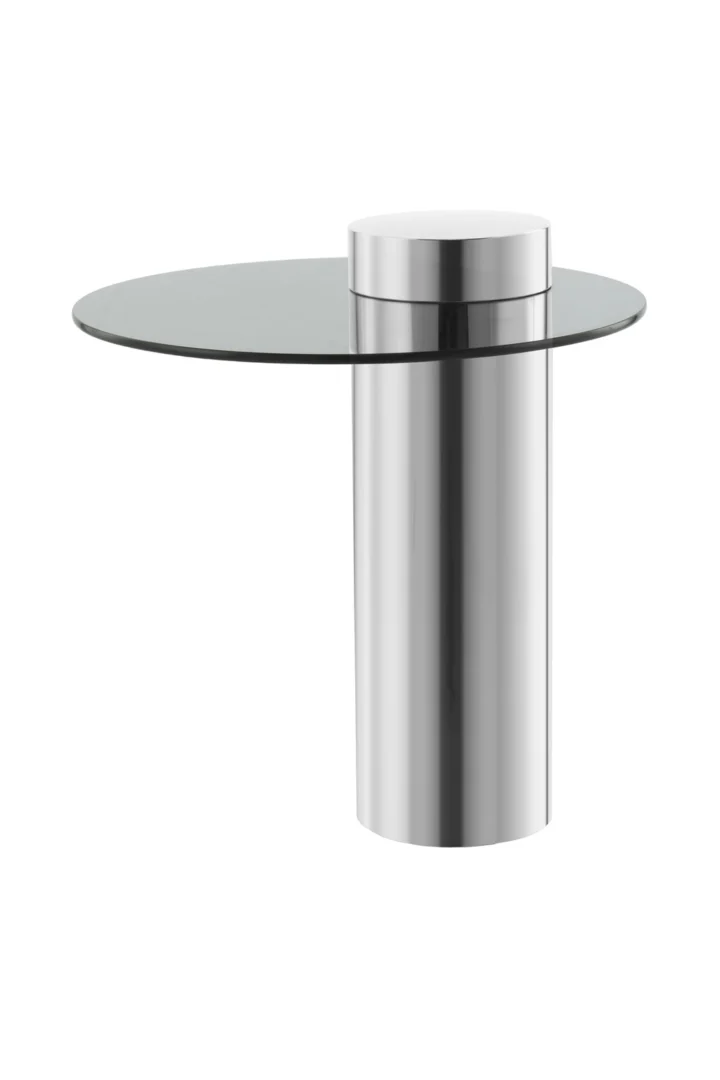 De Bijzettafel Zilver, Grijs Staal Compact is een moderne bijzettafel met een rond blad van helder glas en een cilindrisch, reflecterend metalen onderstel met een minimalistisch en eigentijds ontwerp.