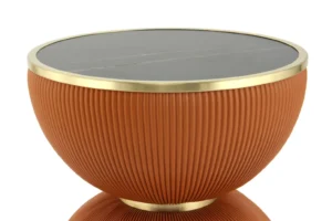 De Bijzettafel Roest Steen is een ronde bijzettafel met een geribbeld, terracottakleurig onderstel, een zwart tafelblad en goudmetallic accenten op de rand en het onderstel.