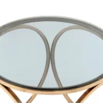 Bijzettafel Grijs Staal Compact met een rond glazen blad en een grijs stalen frame met gebogen steunen, van bovenaf gefotografeerd tegen een witte achtergrond.