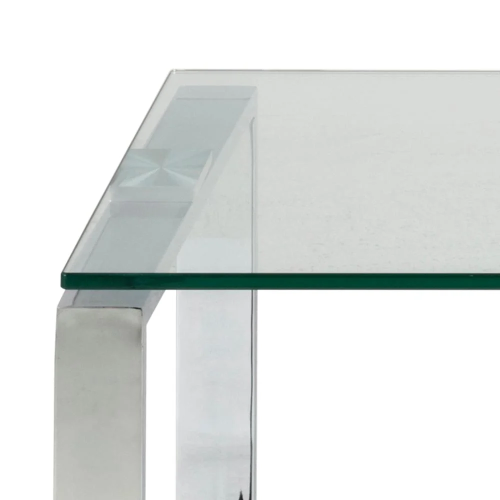 Een close-up van de Salontafel Transparant Rechthoek Glas benadrukt het strakke, minimalistische ontwerp en de transparante glazen poten.