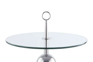 De Bijzettafel Transparant, Zilver Staal is een moderne ronde glazen tafel met een zilver metalen onderstel, voorzien van een centrale paal met een ronde handgreep.