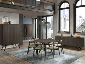 Moderne eetkamer met de NAPOLI BAR + SOKKEL VI-BERG2 E70M, een ronde tafel met zes stoelen, hanglampen, houten kasten, grote ramen en een tapijt met blauw patroon. Loft en stadsgezicht zichtbaar op de achtergrond.