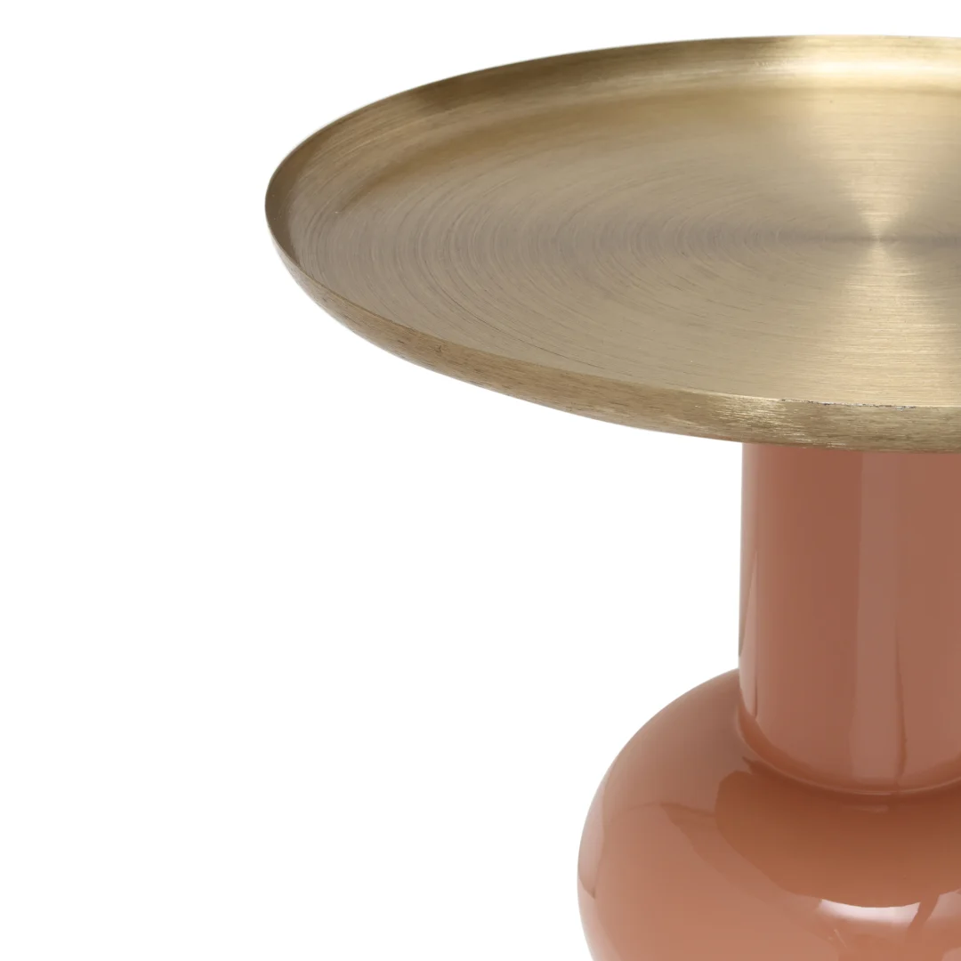 Een close-up van de Bijzettafel Goud Ijzer, met een ronde goudmetallic bovenkant en een glanzende perzikkleurige cilindrische basis, tegen een witte achtergrond.