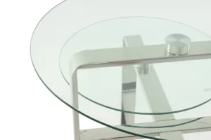 Een close-up van de Bijzettafel Zilver Rond Staal Chique, met een rond glazen blad en glanzend metalen frame met kruisende steunen, die het minimalistische en moderne ontwerp benadrukken.