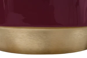 Een close-up van de Bijzettafel Rond Ijzer Design, met een glanzend kastanjebruin bovengedeelte en een geborsteld gouden ondergedeelte met een strakke horizontale scheiding tussen de afwerkingen.