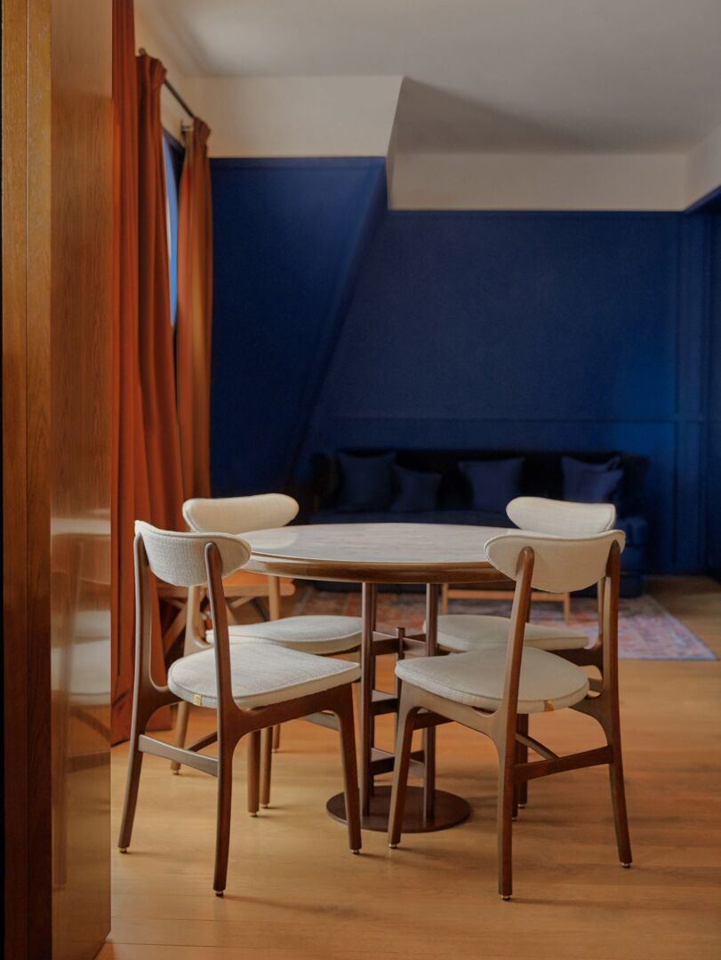 Eetkamerstoel 200-190 Fluweel Schildpad Met Naturel Hout bij een ronde eettafel.