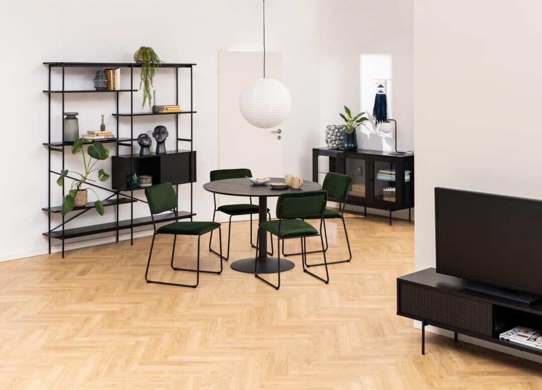 Eetkamer met ronde tafel en groene Cornelia eetkamerstoelen (set van 2), zwarte kast en stellingkast.