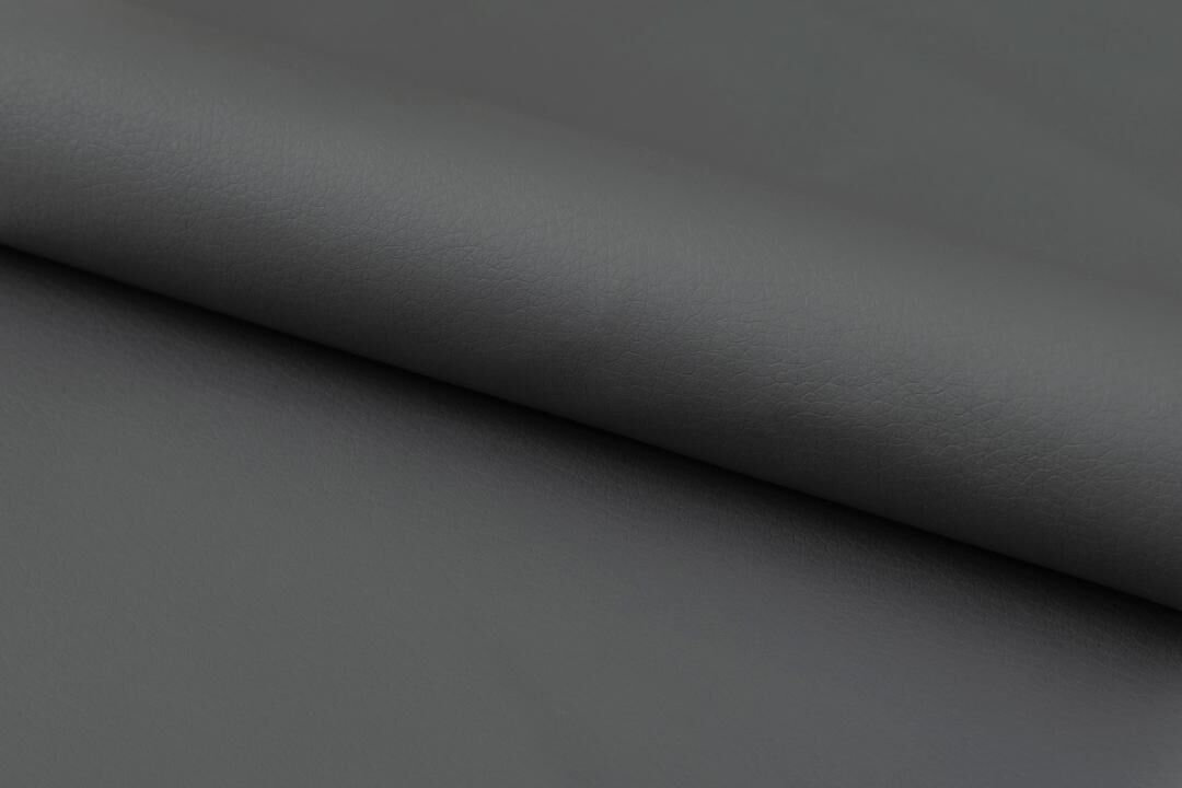 Eris eetkamerstoel (set van 4): close-up van grijze kunstleren bekleding met subtiele textuur en plooien.