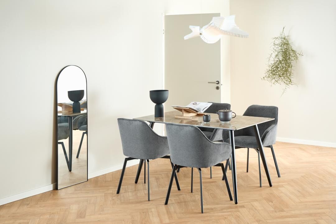 Clara eetkamerstoel met armleuning (set van 2) aan een eettafel in een lichte eetkamer.