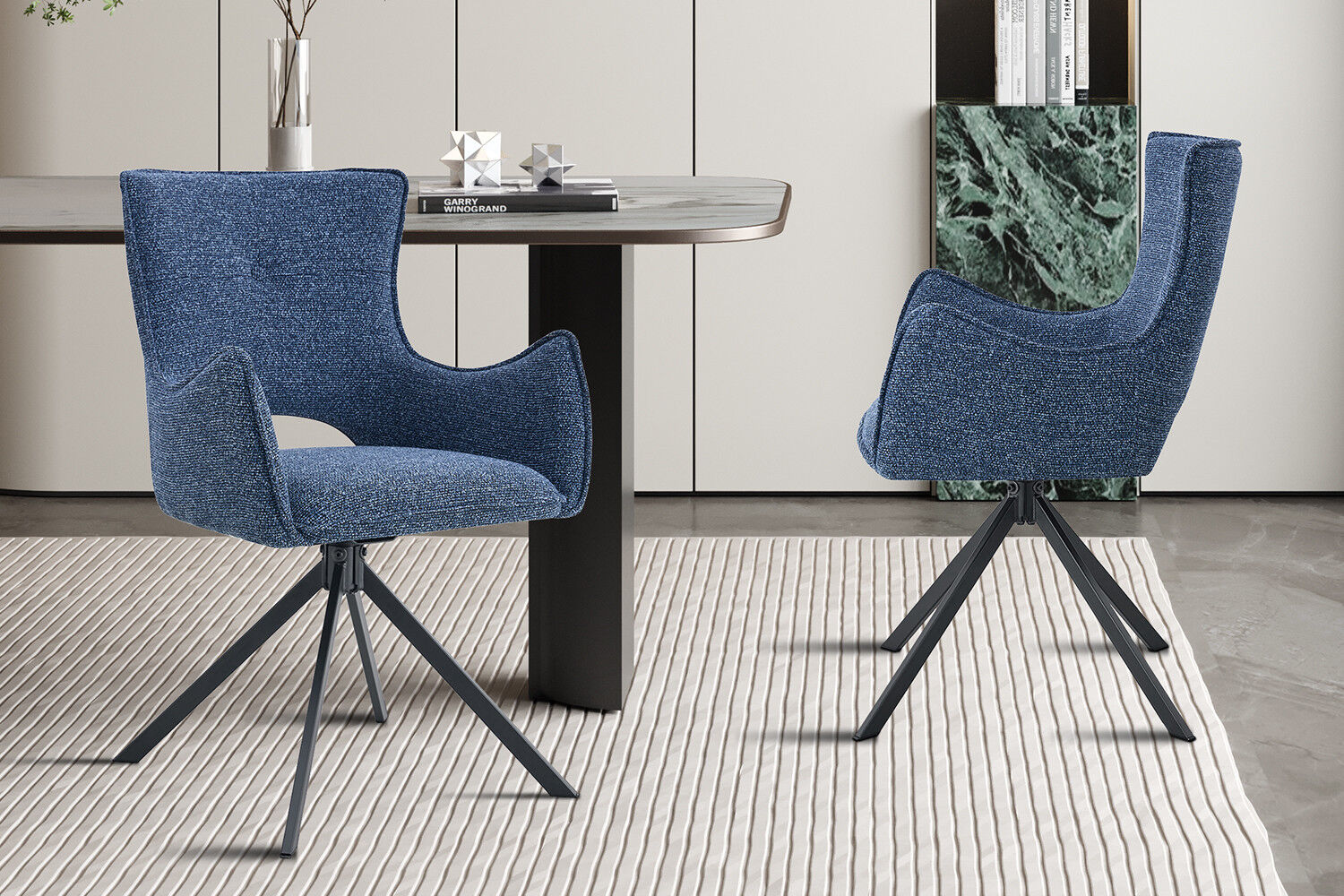 Eetkamerstoel Billy Blauw Draaibaar: Blauwe gestoffeerde stoel met zwarte draaivoet aan een moderne eettafel.