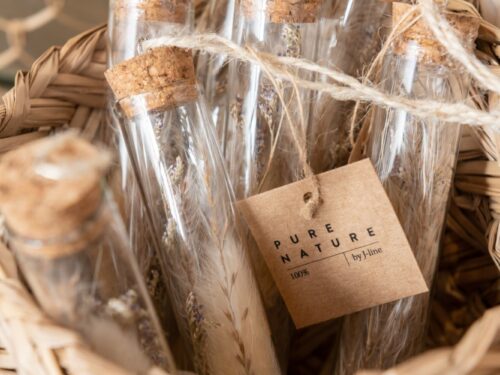 Set van 2 hangende glazen buisjes met droogbloemen, kurk en naturel touw in rotan mand