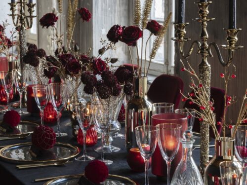 Jaarmone transparant drinkglas met goudkleurige rand op luxe gedekte tafel