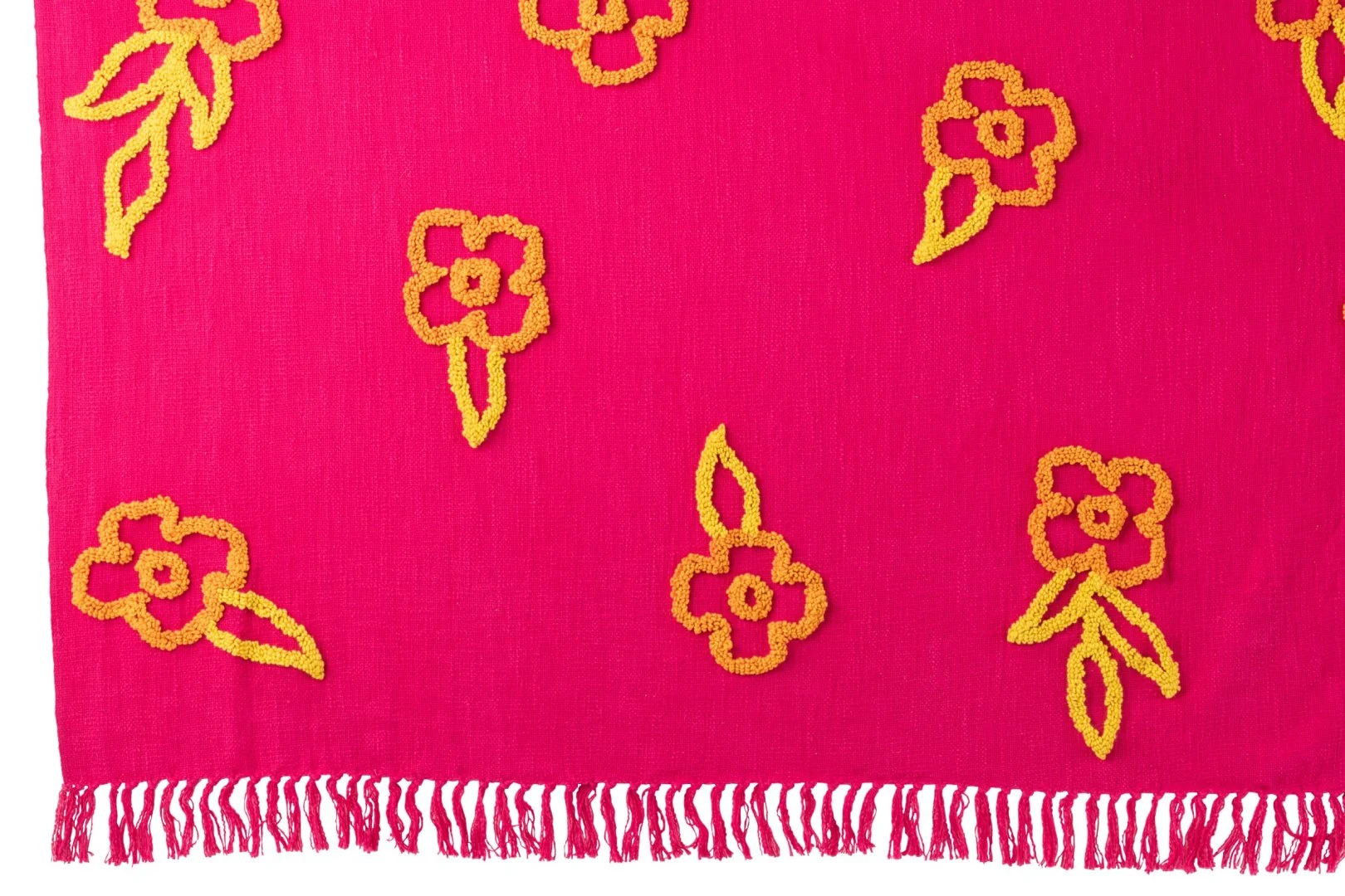 Klaansy plaid roze katoen met geel-oranje bloemen en speelse franjes voor een vrolijke, zachte woonlook