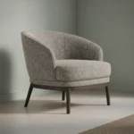 Fauteuil Ravulrocca van stof met ronde rug, comfortabele zitting en donkere houten poten.
